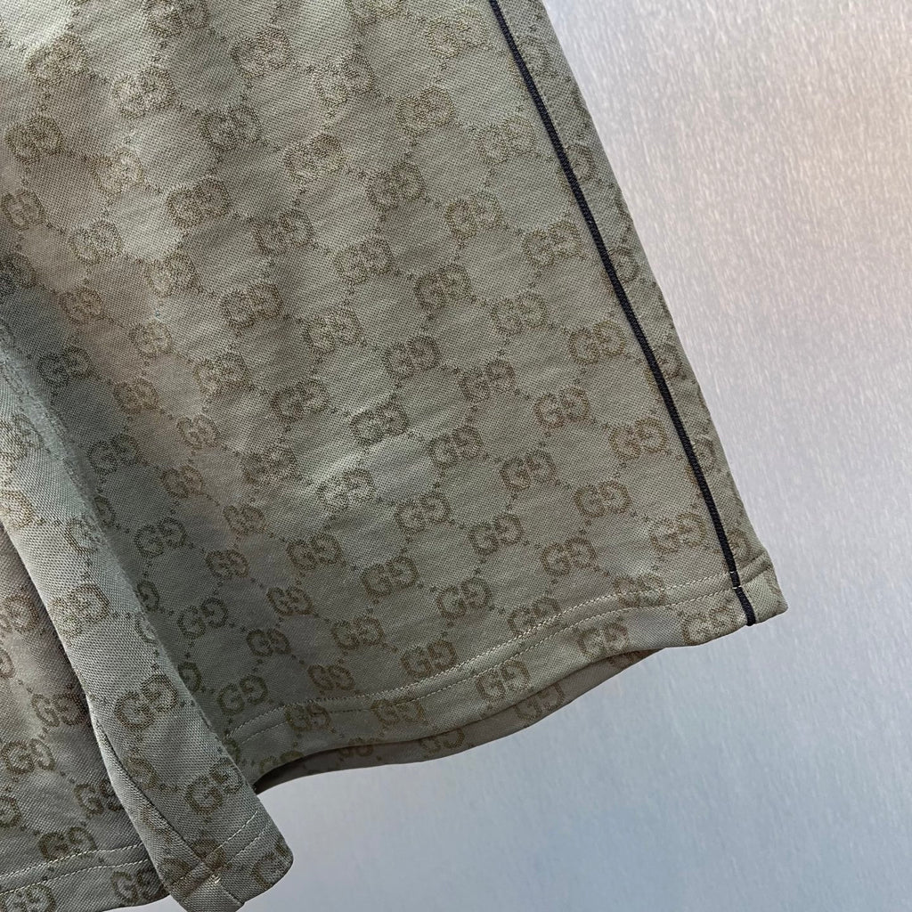 Hem and side seam of GG monogram shorts in olive-brown.