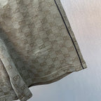 Hem and side seam of GG monogram shorts in olive-brown.