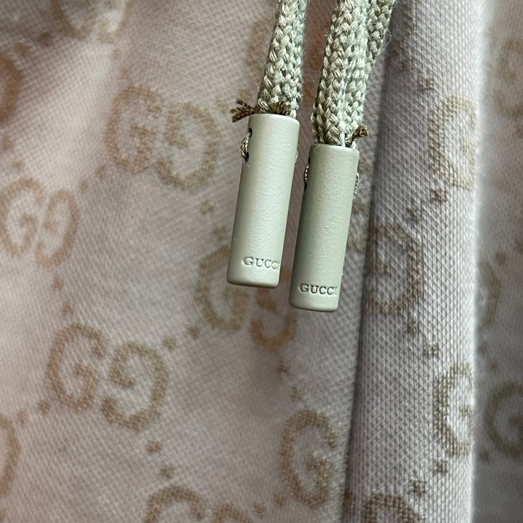 Gucci drawstring cords with metal tips on GG monogram shorts.