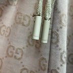 Gucci drawstring cords with metal tips on GG monogram shorts.