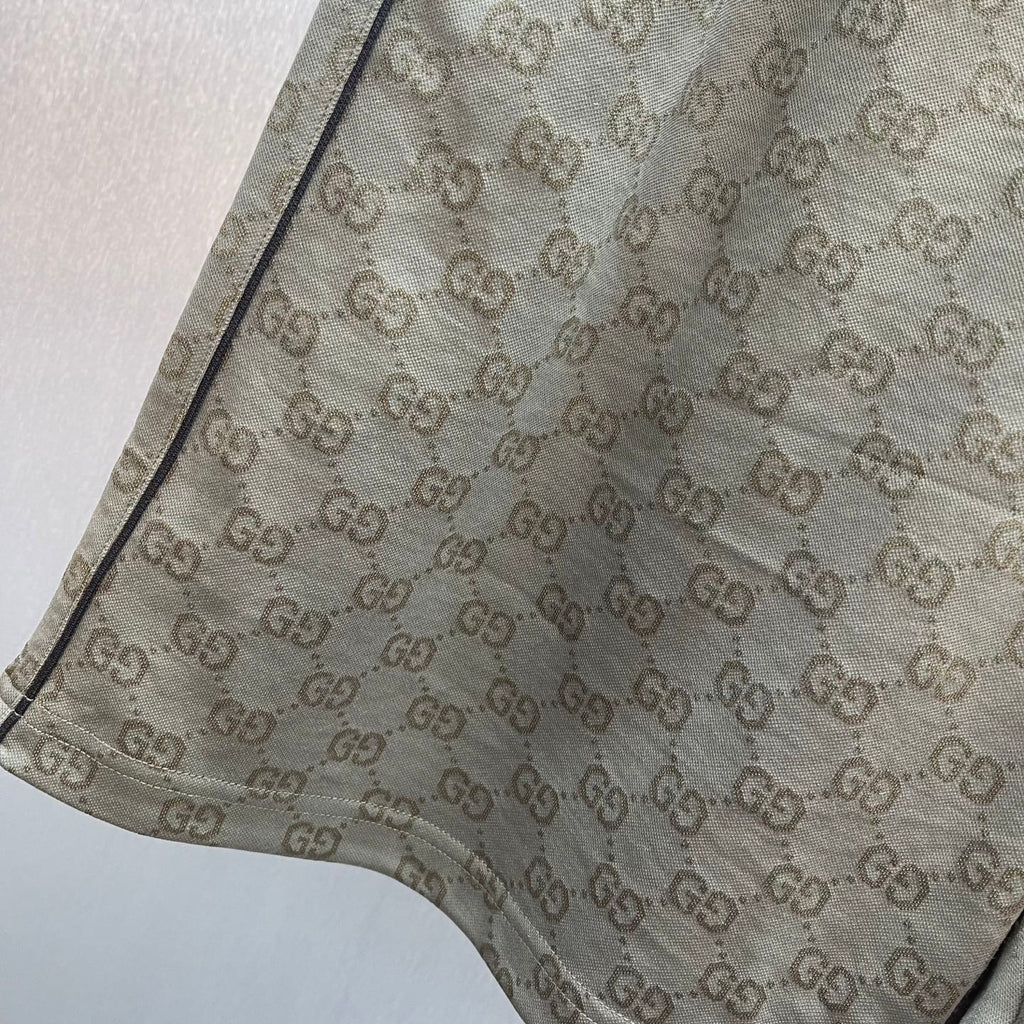GG monogram shorts with textured fabric and curved hem detail, olive-brown.