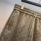 Men's GG monogram shorts with elastic waistband, drawstring ties, and side pockets.
