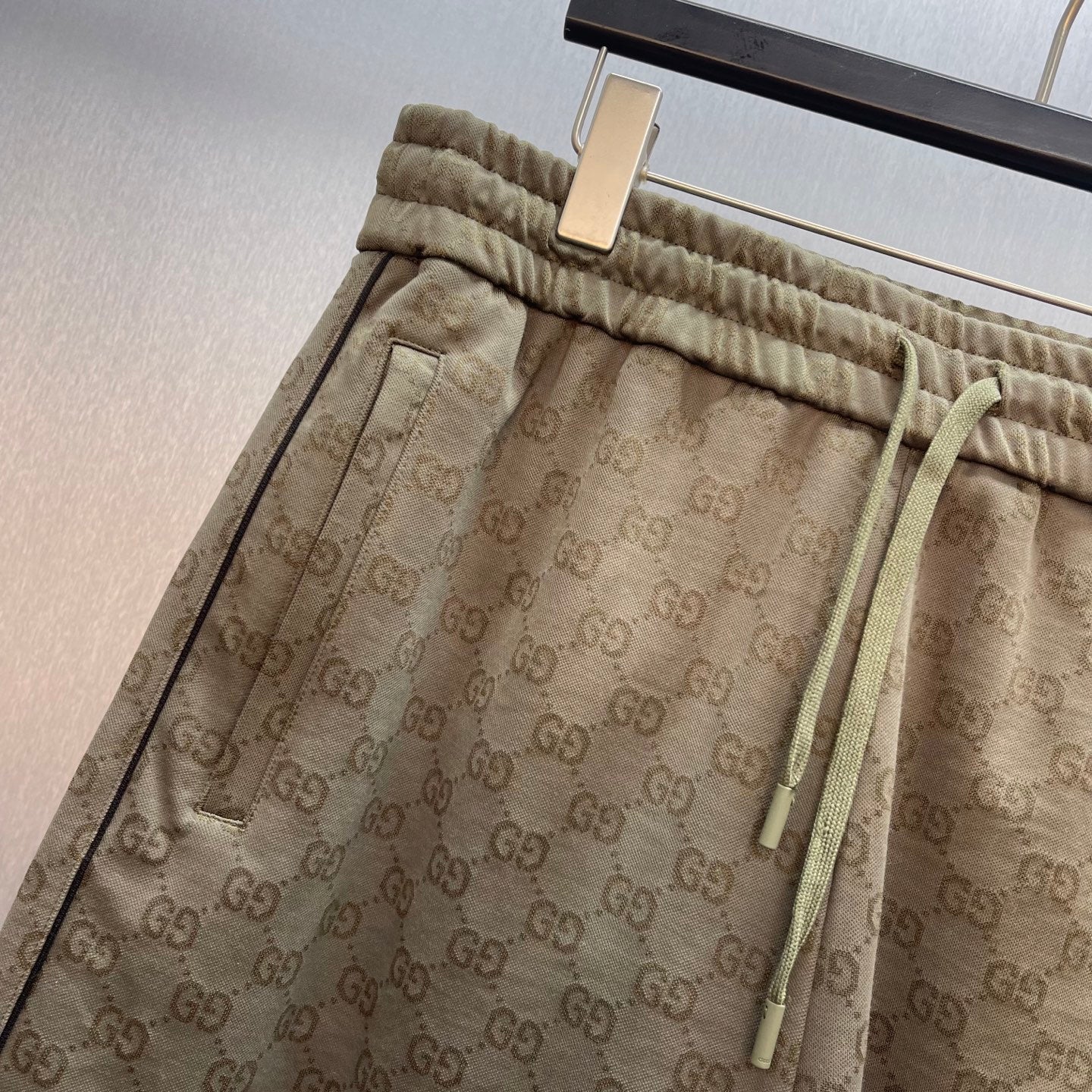 Men's GG monogram shorts with elastic waistband, drawstring ties, and side pockets.