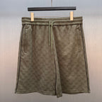 Men's drawstring shorts with GG monogram pattern and elastic waistband, olive-brown.