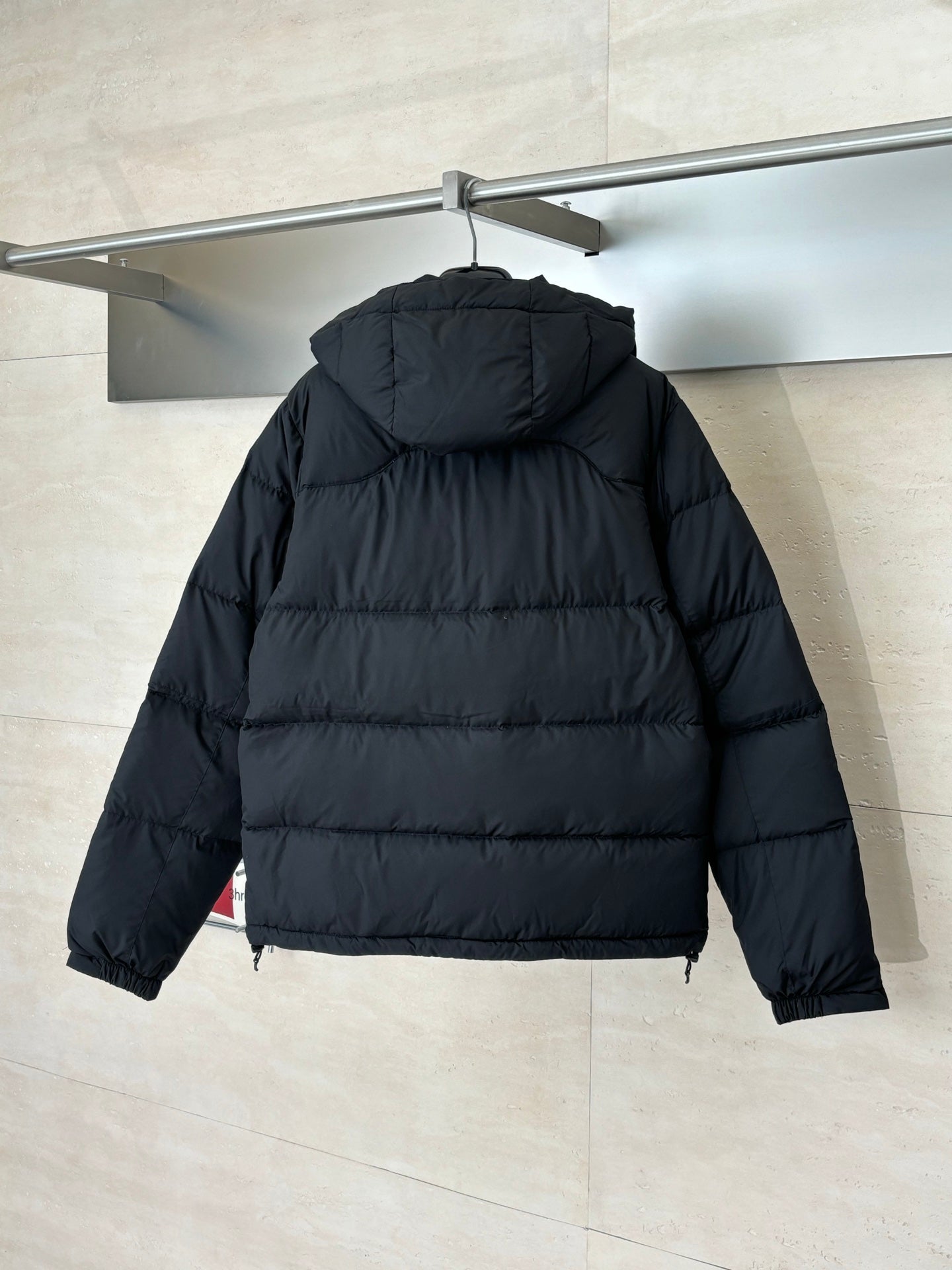 Ralph Lauren black puffer jacket, rear view with attached hood and zipper