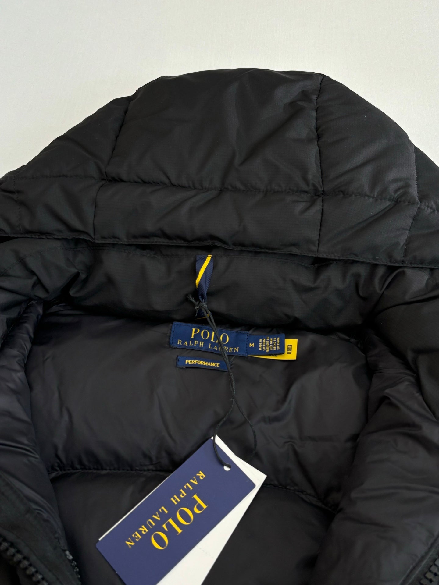 Ralph Lauren black puffer jacket collar with brand tag and Polo label