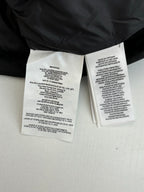 Inside Ralph Lauren puffer jacket care labels on white fabric tags