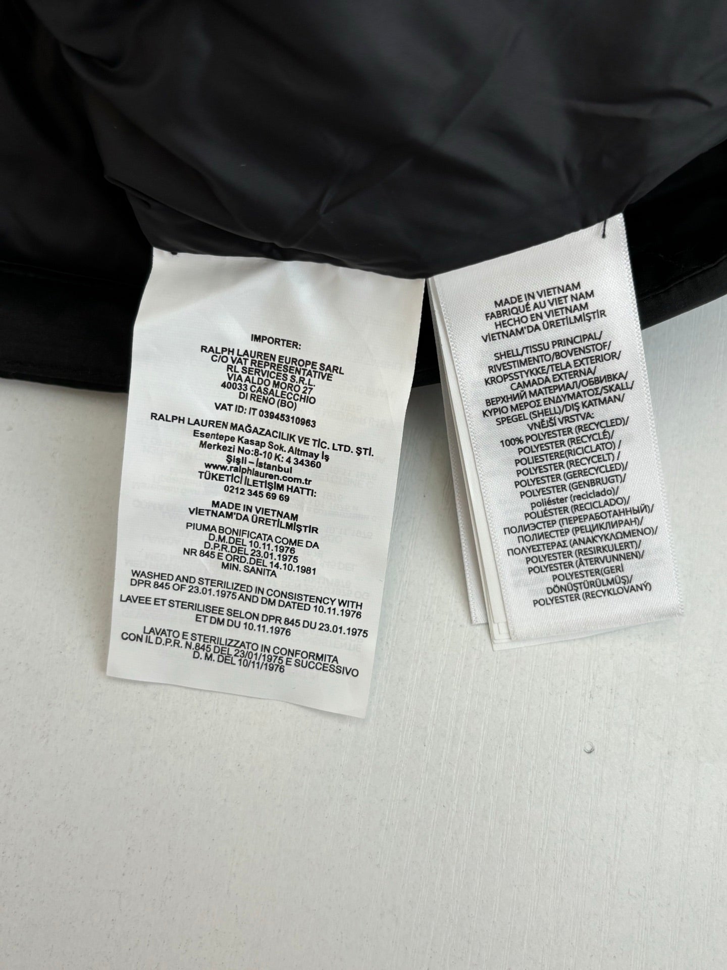 Inside Ralph Lauren puffer jacket care labels on white fabric tags