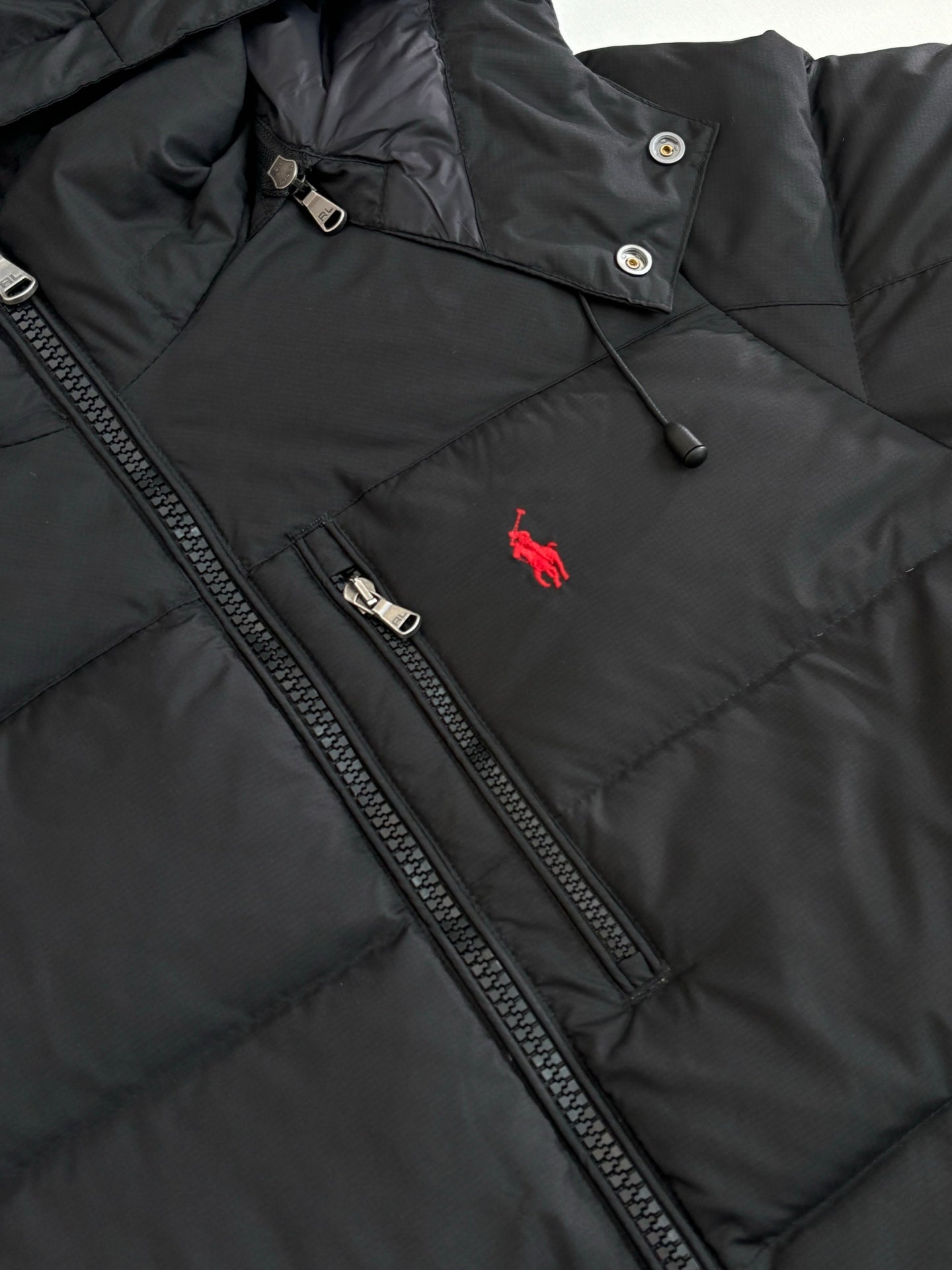 Ralph Lauren black puffer jacket chest details, full-zip and red horse logo
