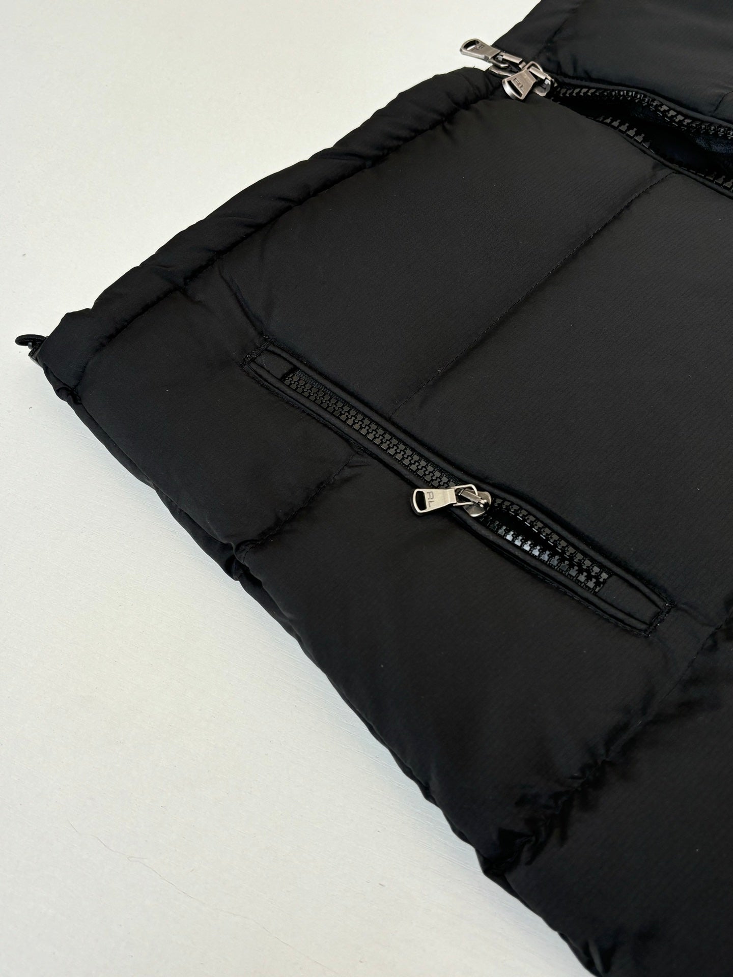 Ralph Lauren black puffer jacket side with zip pocket and metal hardware