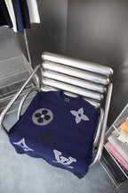 Navy T-shirt folded on a metal chair with LV flower and monogram prints