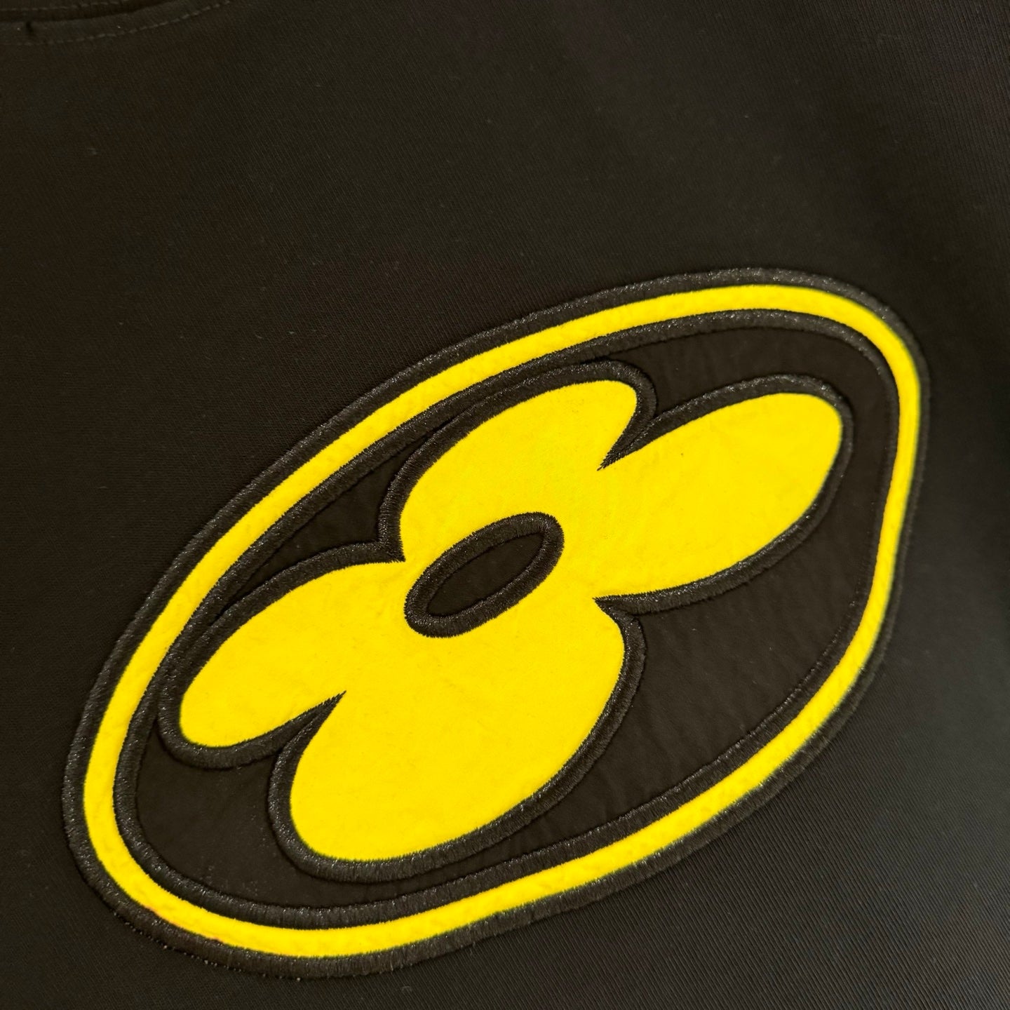 Yellow smiley graphic patch on black Louis Vuitton T-shirt