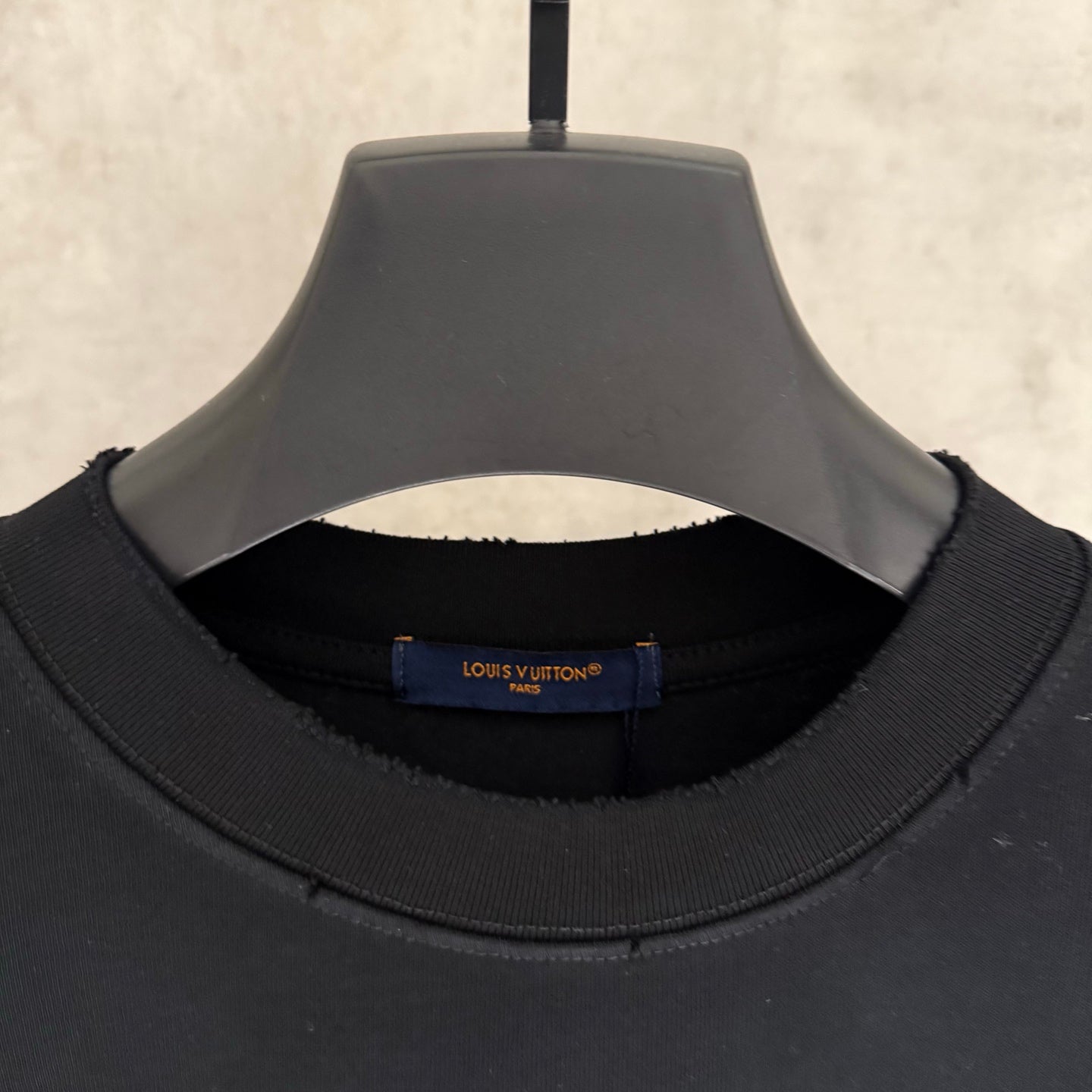 Louis Vuitton T-shirt neckline detail with inner brand label "LOUIS VUITTON" "PARIS"