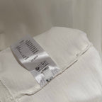 White short-sleeve T-shirt with fabric care label inside the hem