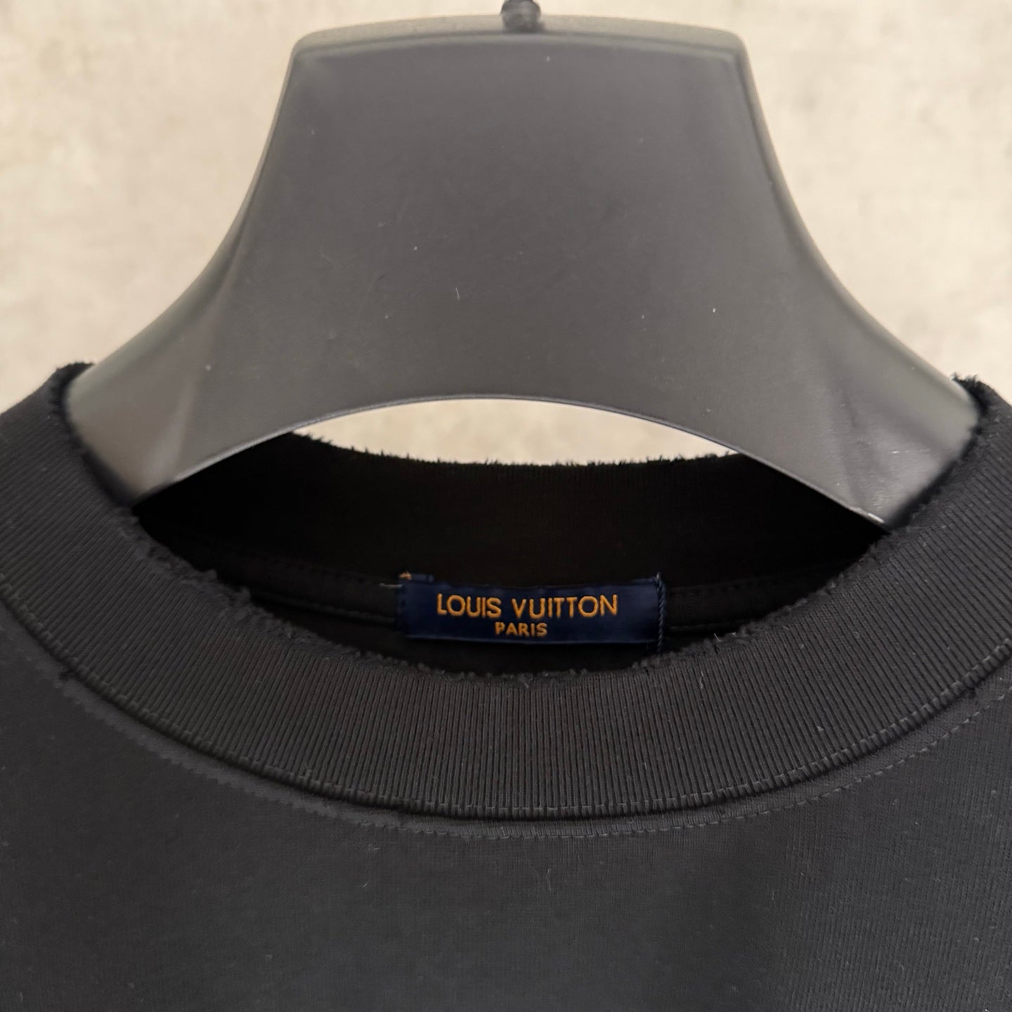 Black T-shirt collar with Louis Vuitton neck label