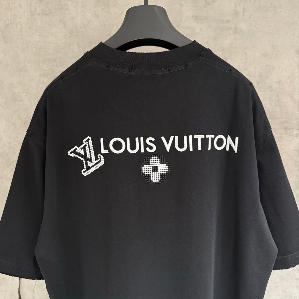 Louis Vuitton black T-shirt close-up with rhinestone “LOUIS VUITTON” and clover on back
