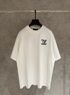 White short-sleeve T-shirt with black LV logo chest on a hanger
