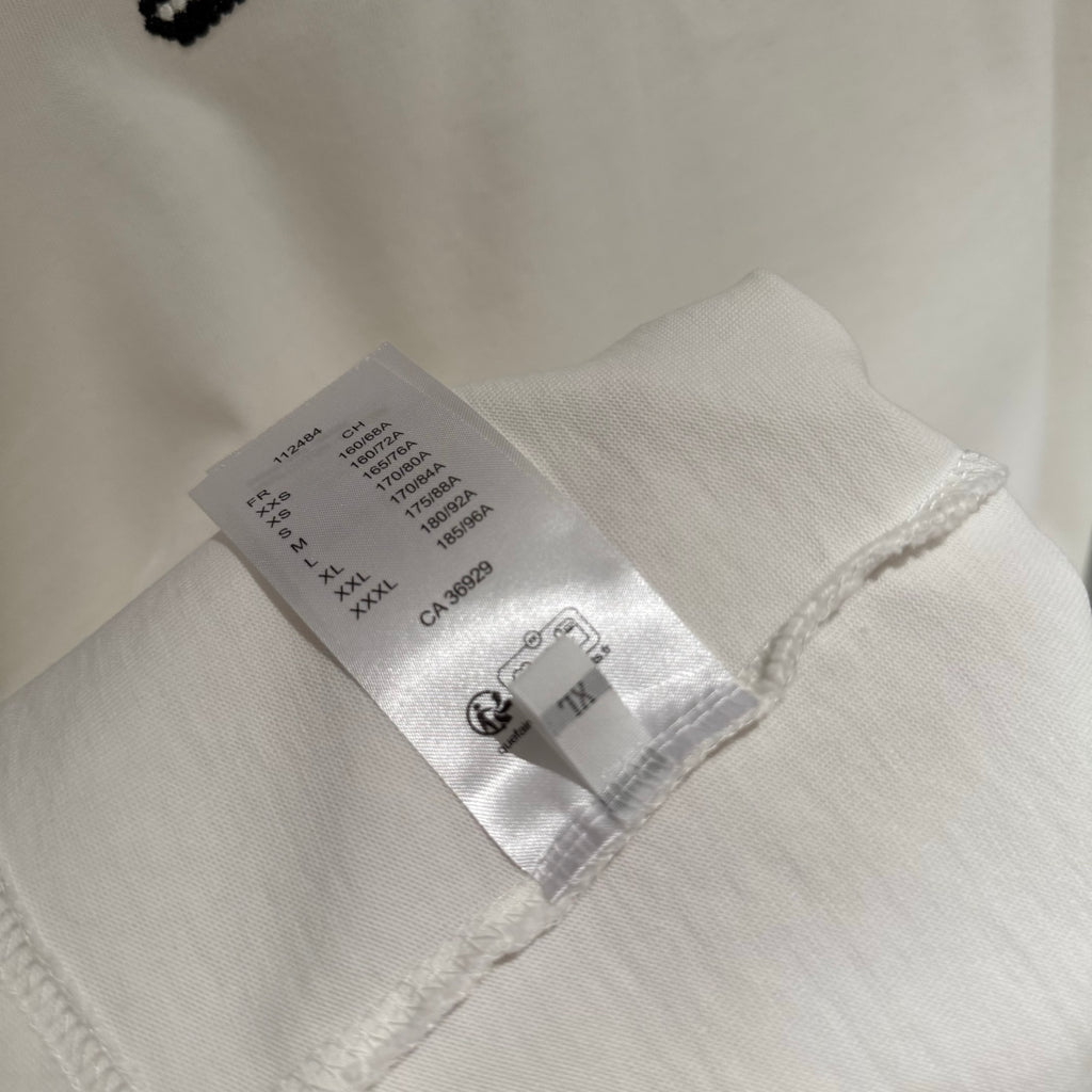 White T-shirt inner neck label and fabric tag near hem