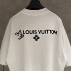White short-sleeve T-shirt with Louis Vuitton text and black clover emblem on back