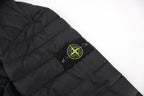 Stone Island logo patch on black puffer jacket sleeve
