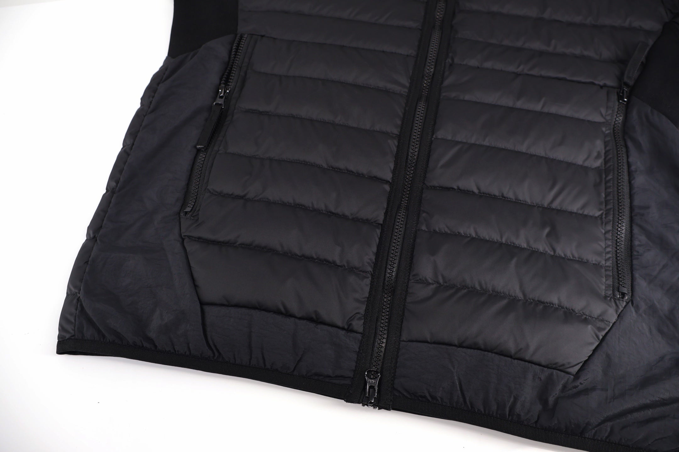Stone Island black puffer jacket with front zipper and horizontal quilted panels