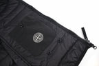 Black puffer jacket inner pocket panel with snaps and Stone Island circular patch