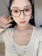 Gold-tone beaded necklace and matching hoop earrings with pastel crystals