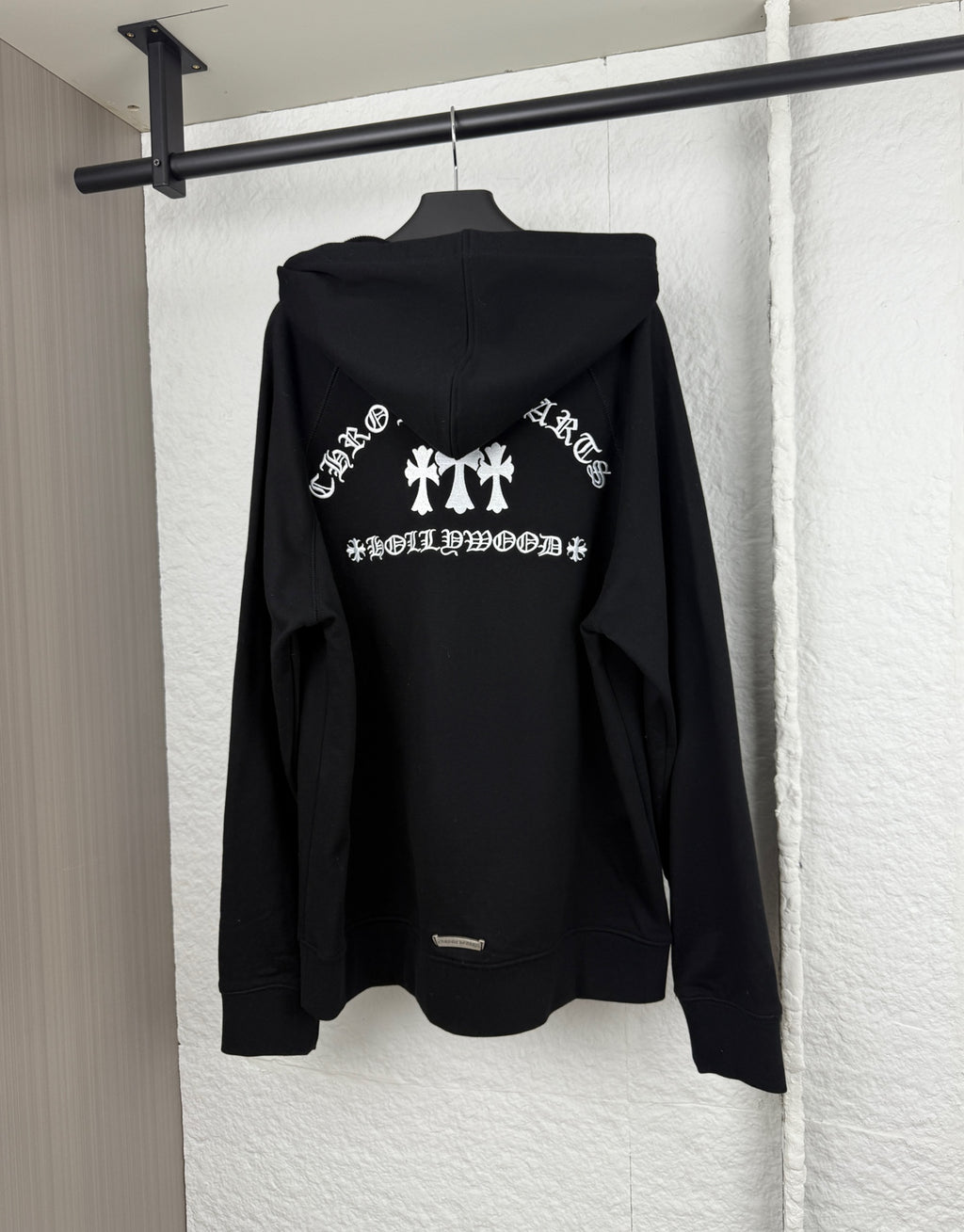 Black hoodie back view with large white graphic and attached hood