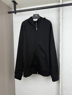 Black zip-up hoodie with attached hood and front kangaroo pocket