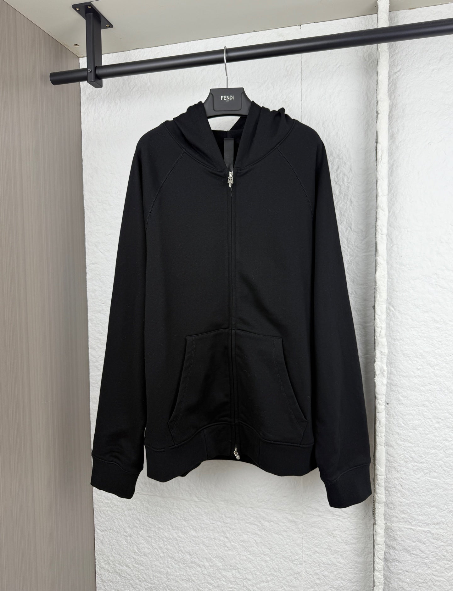 Black zip-up hoodie with attached hood and front kangaroo pocket