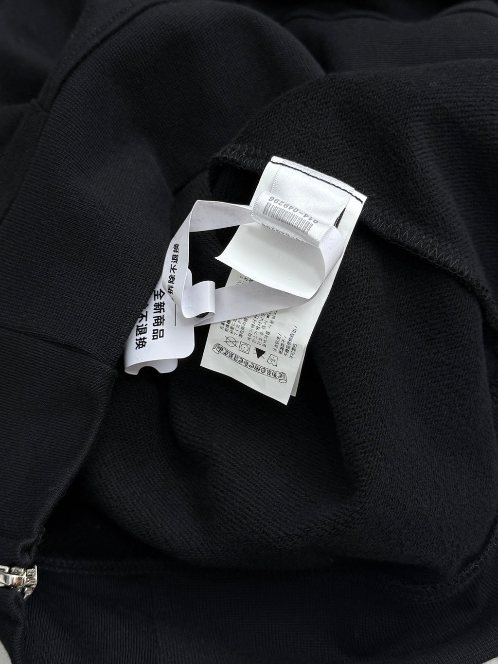 Black hoodie with interior hood label at neckline