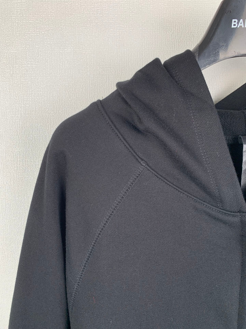 Black zip-up hoodie shoulder and hood seam details