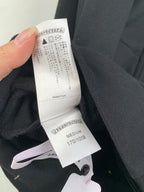 Black hoodie care and size tag showing Medium
