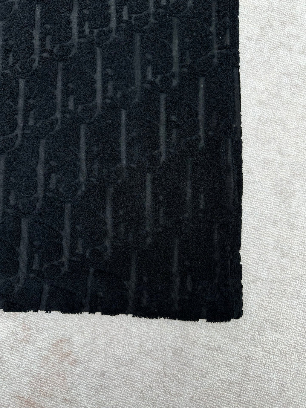 Black Dior T-shirt fabric close-up, side panel and hem