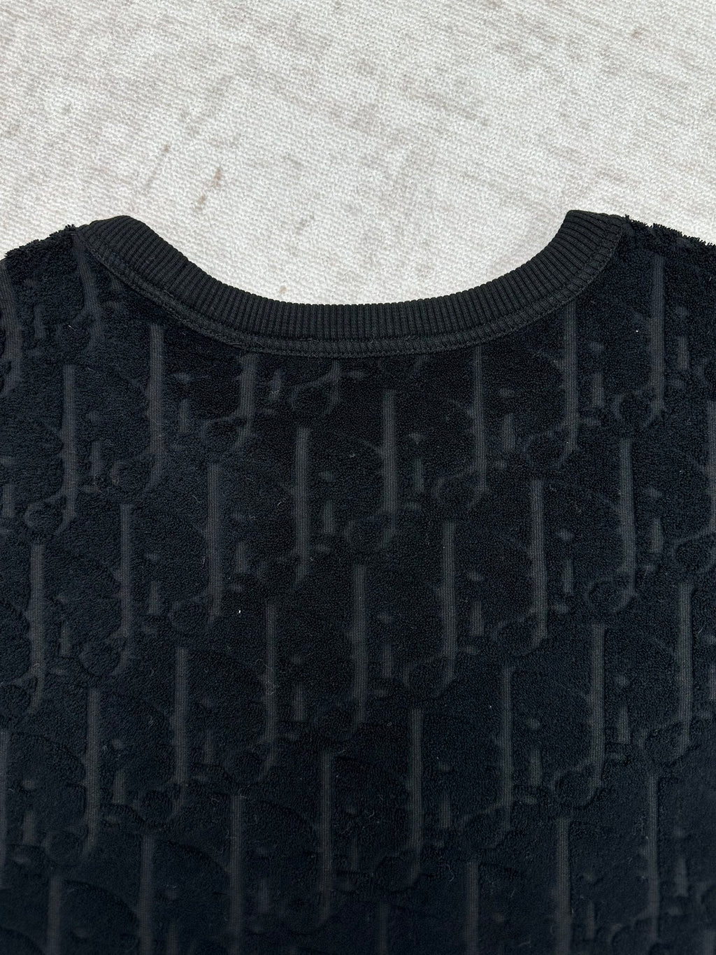 Black Dior crew-neck T-shirt front close-up, textured logo