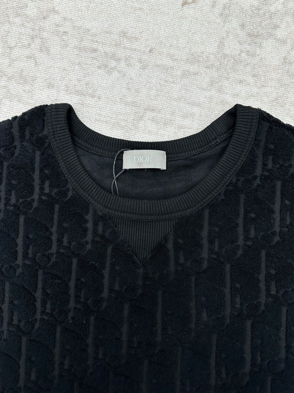 Black Dior crew-neck T-shirt close-up, jacquard pattern