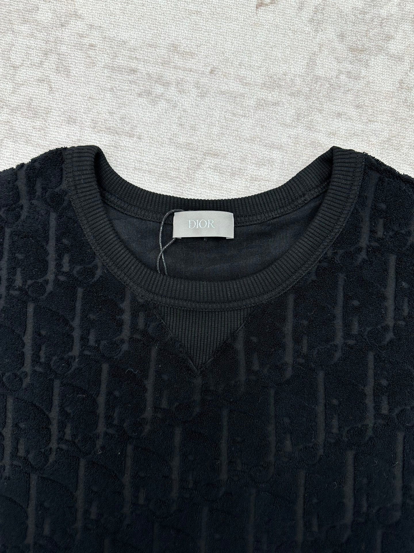 Black Dior crew-neck T-shirt close-up, jacquard pattern