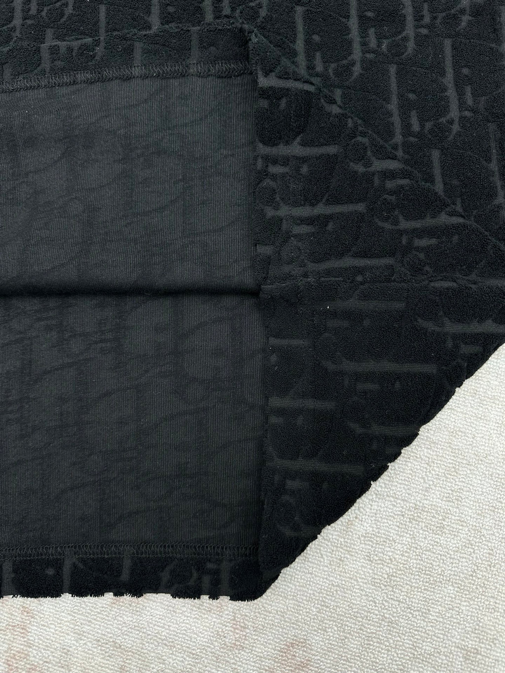 Black Dior T-shirt folded hem and seam close-up