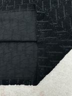 Black Dior T-shirt folded hem and seam close-up