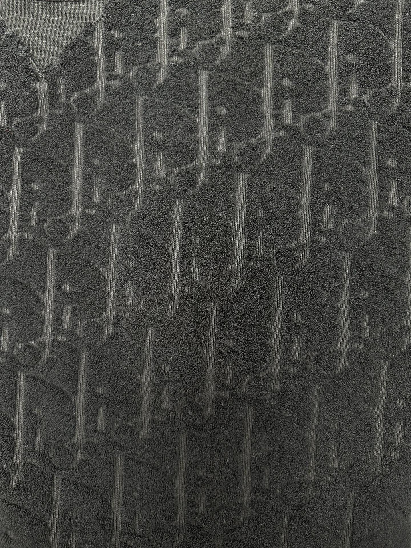 Black Dior jacquard logo texture fabric close-up