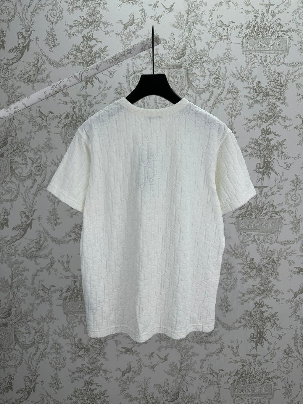 White Dior crewneck T-shirt on hanger, short sleeves and embossed fabric texture
