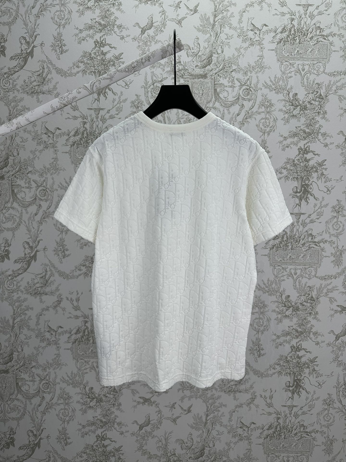 White Dior crewneck T-shirt on hanger, short sleeves and embossed fabric texture