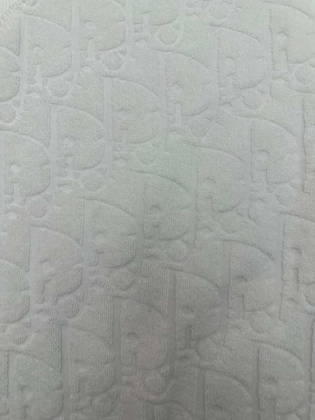 White embossed textured fabric on a short-sleeve crewneck T-shirt