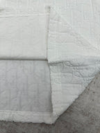 White crewneck T-shirt with embossed fabric and folded side hem detail