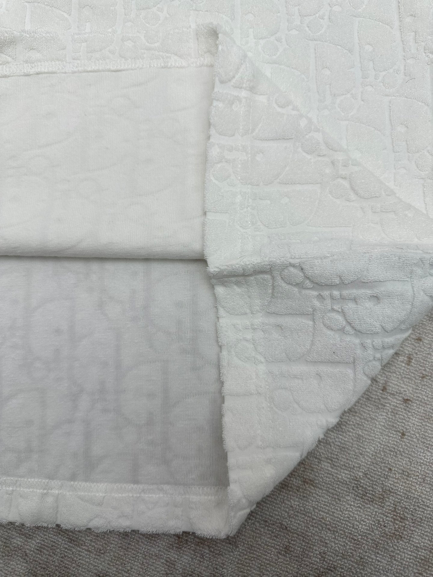 White crewneck T-shirt with embossed fabric and folded side hem detail