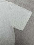 White short-sleeve T-shirt sleeve with embossed fabric texture and turned hem
