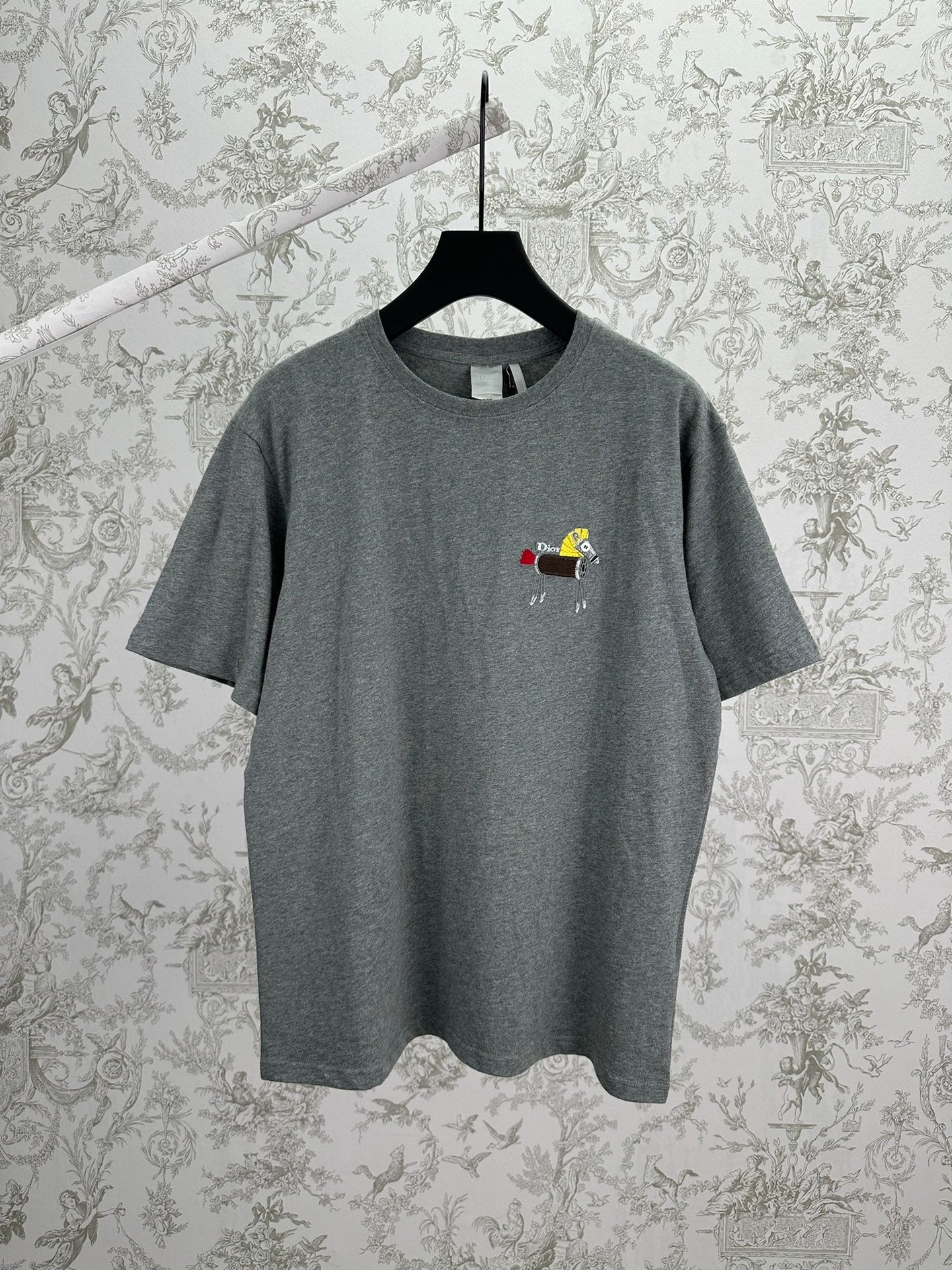 Grey short-sleeve T-shirt with crew neck and small embroidered front graphic