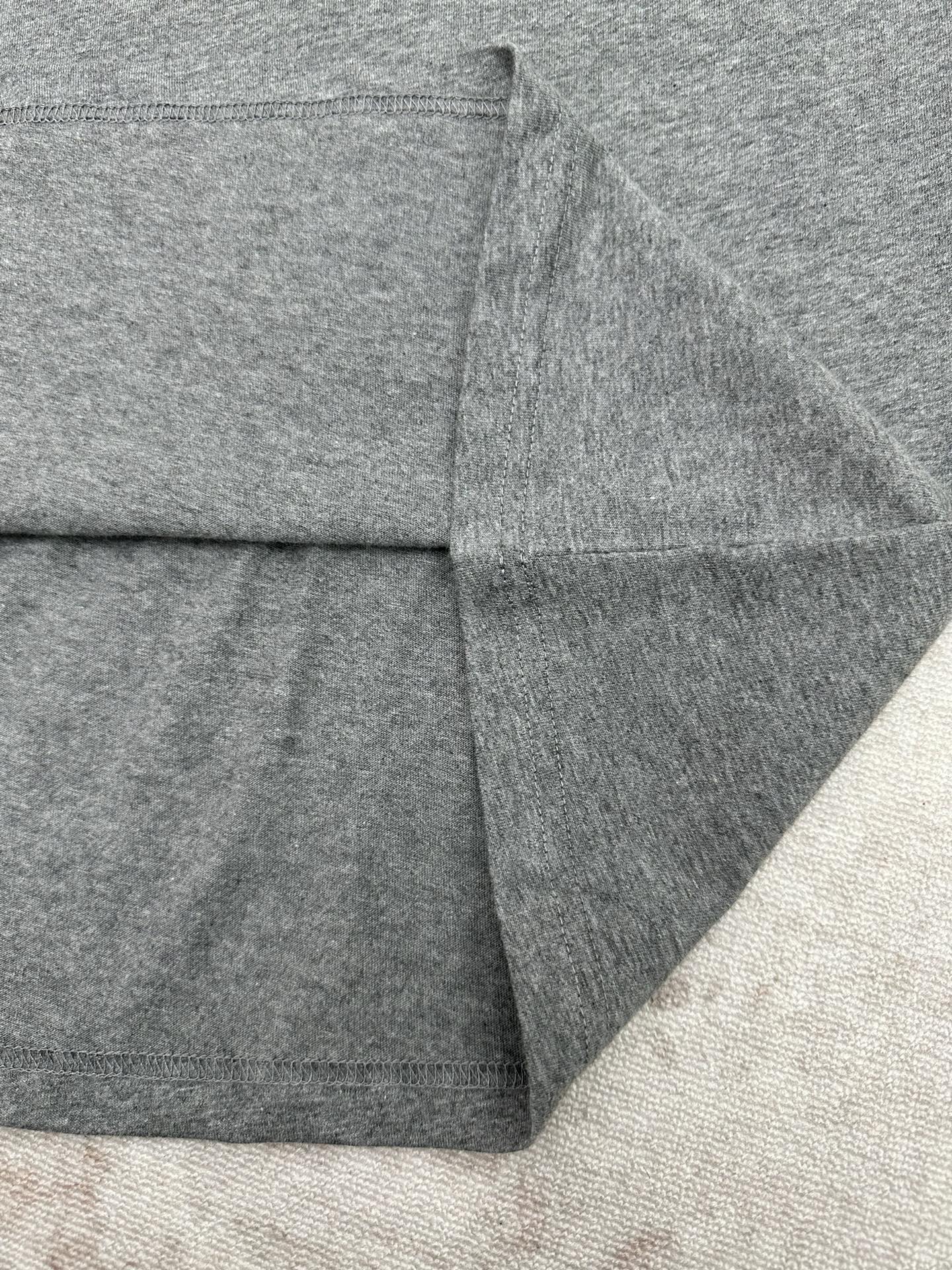 Grey T-shirt back hem and stitched seam close-up