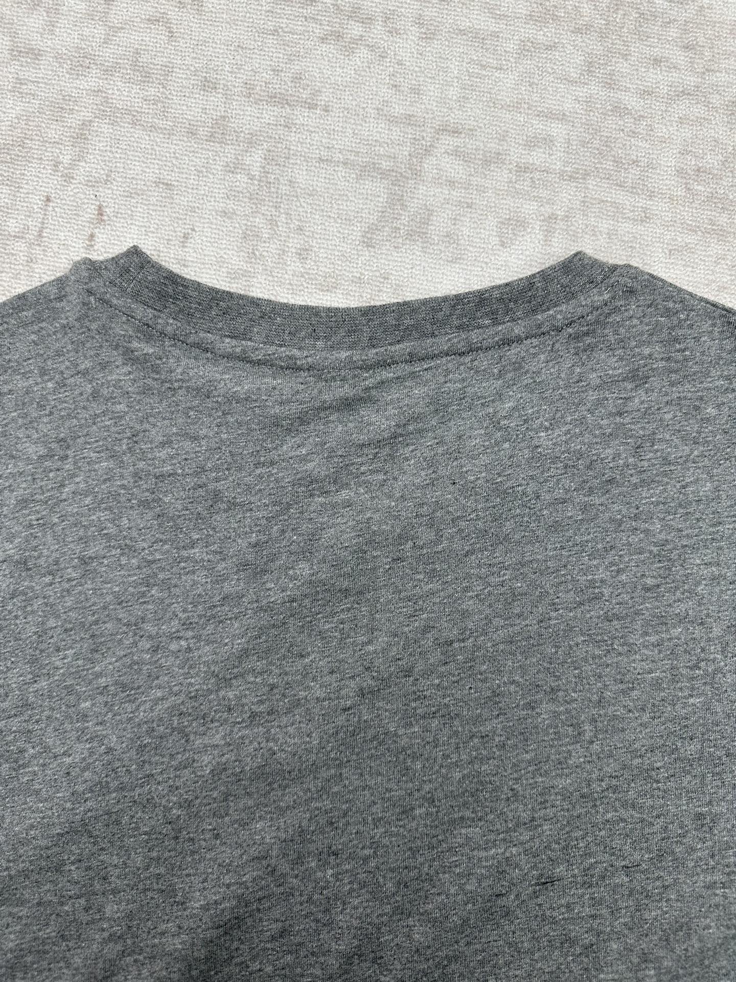 Grey crew-neck T-shirt collar and upper chest area, no visible graphic