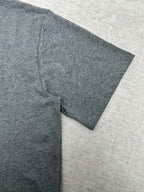 Grey T-shirt sleeve and side seam close-up